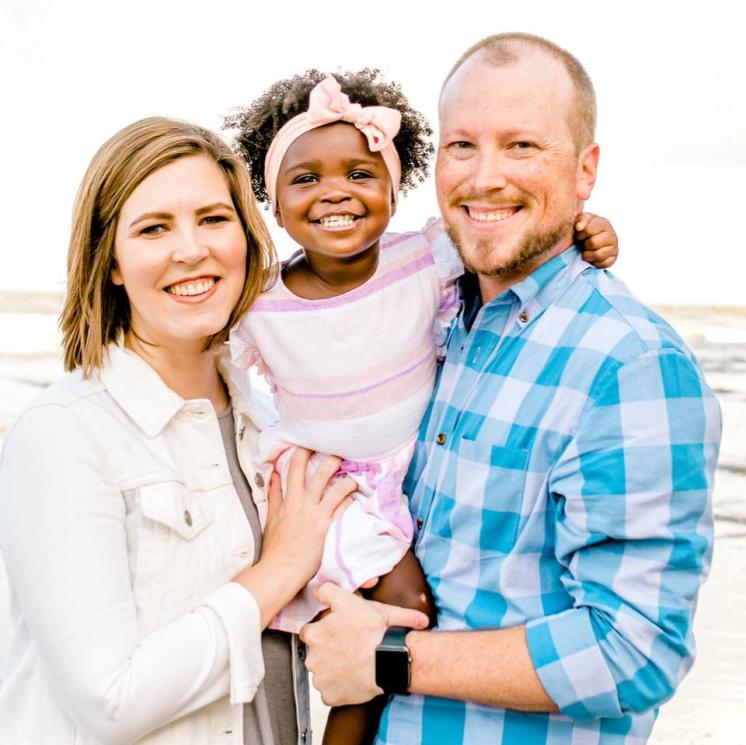 Kyle Jackson A man and women with a little girl smiling at the camera