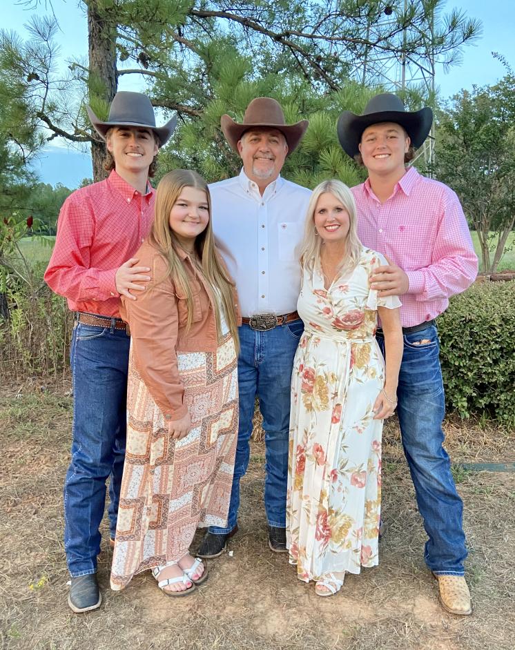 Family of 5. Three cowboys and two woman in dresses.