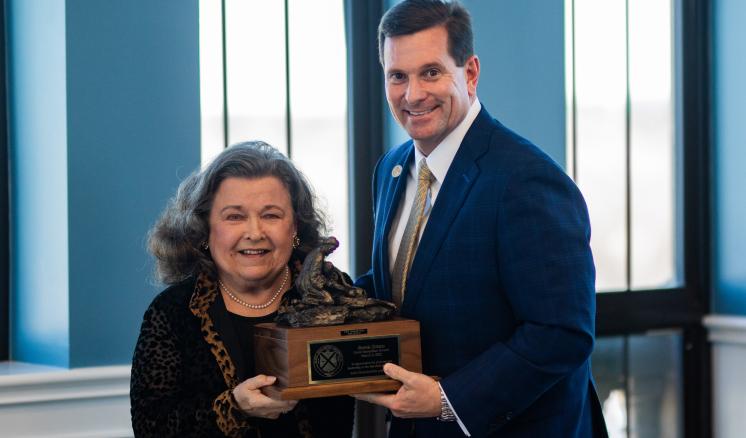 2022 Good Samaritan A man and a woman smiling at the camera with an award in between them