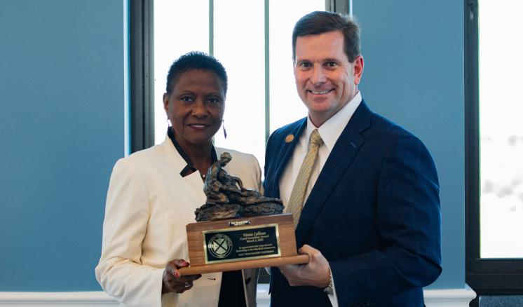 2022 Good Samaritan A man and a woman smiling at the camera with an award in between them