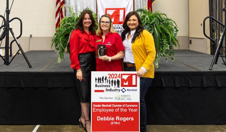 Debbie Rogers Employee of the Year Three women posing with employee of the year award smiling at the camera